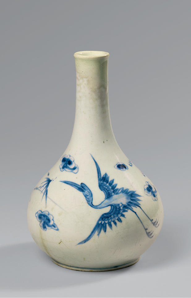Bottle with flying cranes and clouds